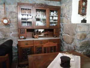 a wooden cabinet in a room with a table at CASIÑA OS LUEIRO in Portas