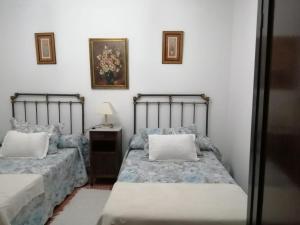 a bedroom with two beds and a table with a mirror at CASIÑA OS LUEIRO in Portas