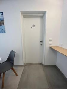 a door in a room with a chair and a desk at B&B Casa Laforgia Soffio Mediterraneo in Polignano a Mare