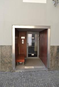 a door to a building with a bench in it at Luxury apartment with a balcony and view in Riga Old Town in Riga