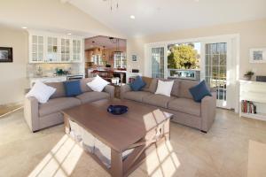 a living room with a couch and a table at Pleasure Point Retreat in Santa Cruz