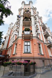 a tall building with flower boxes on it at Monika Centrum Hotels in Rīga