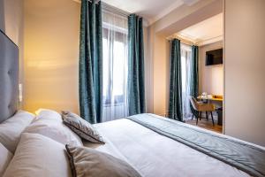 a bedroom with a bed and a window and a table at Boutique Hotel Borgo in Florence