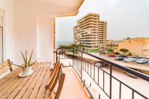 a balcony with benches and a view of a city at Expoholidays - Apartamento Montesol in Aguadulce