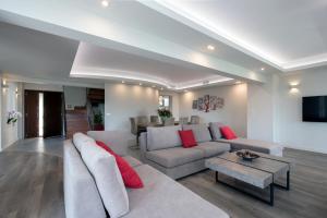 a living room with a couch and a table at Gem Villa in Viros Corfu in Virós
