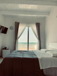Säng eller sängar i ett rum på CARFAGNINI ROOMS