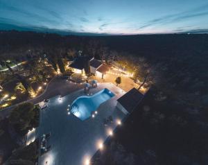 una vista aerea di una casa con piscina di notte di Otto Apulia House B&B ad Andria