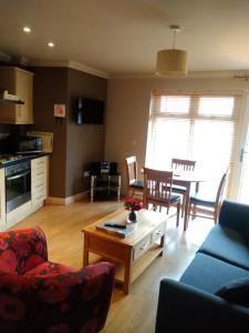 a living room with a couch and a table at Victoria Cloisters Apartments in York