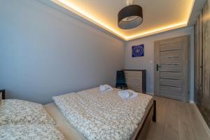 Posteľ alebo postele v izbe v ubytovaní Widok z Centrum