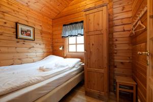 a bedroom with a bed in a wooden cabin at Nupar Cottages in Ölfus