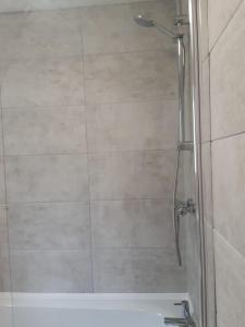 y baño con ducha y puerta de cristal. en Cheerful home close to the city and Peak District en Neepsend