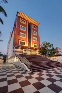 a building with stairs in front of a building at Click Hotel Guwahati in Guwahati