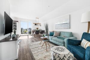 a living room with a blue couch and a table at FeWo Olpenitz in Olpenitz