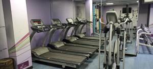 a row of tread machines in a gym at Golden Tulip Al Khobar in Al Khobar