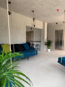 a swing in a living room with a blue couch at Moro Inn in Korčula