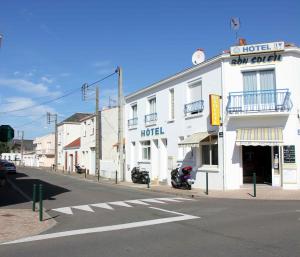 a hotel with a motorcycle parked in front of a street at Hotel le Bon Soleil in Les Sables-d'Olonne