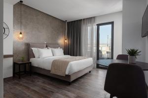 a hotel room with a bed and a desk and a bed at Athenian Spirit in Athens