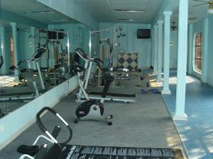 a gym with several exercise equipment in a room at Valley View Guest House in Mogwase