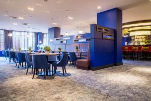 a restaurant with tables and chairs in it at Radisson Blu Sobieski in Warsaw