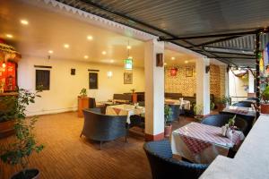 a restaurant with tables and chairs in a room at KATHMANDU NOMAD HOTEL in Kathmandu