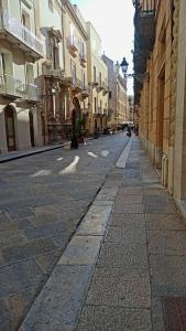 an empty street in a city with buildings at Civico 22 in Trapani