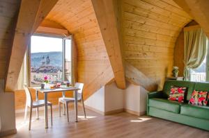 a living room with a table and a green couch at Turin Sweet Home in Turin