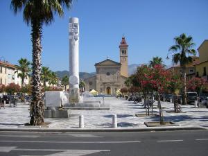 a town square with a clock tower and a building at L'orologio matto in Marina di Carrara