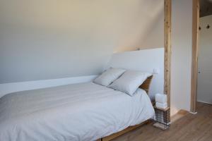 a bedroom with a bed with a white bedspread at Penty morgat in Crozon