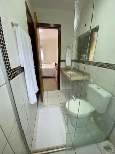 a bathroom with a shower and a toilet and a sink at Casa em Condomínio, Aquiraz - CE in Aquiraz