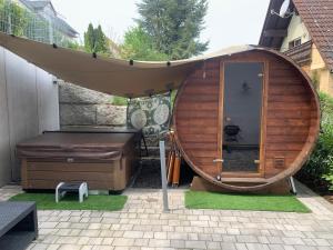 a hot tub and a bed in a backyard at 4 * Wohnung SPA Whirlpool & Sauna in Seenähe in Ramsberg