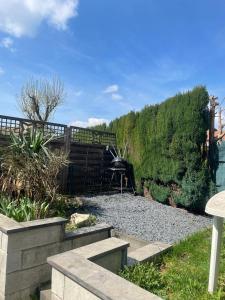 a garden with a bench and a table and gravel at Superbe Appartement au RDC avec cheminée in Villerupt