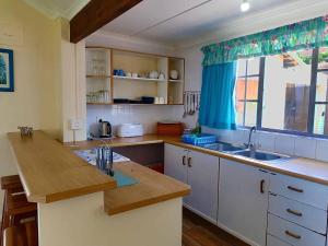 a kitchen with a counter and a sink and a window at Southern Comfort - On the Rocks in Margate