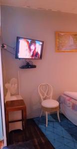 a room with two chairs and a tv on the wall at Bedfort Accommodation in Cape Town +14 photos