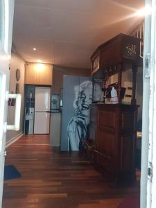 a living room with a kitchen with a refrigerator at Bedfort Accommodation in Cape Town