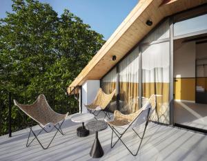 a group of chairs and a table on a deck at Major's House Hotel in Stepʼanavan