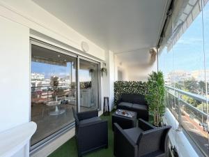 a living room with a couch and chairs on a balcony at Maryline by Welcome to Cannes in Cannes