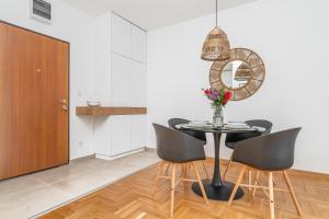 a dining room with a table and chairs at Central One-Bedroom Apartment in Budva