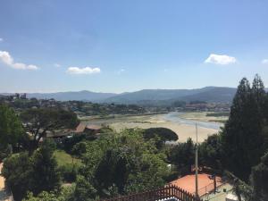 a view of a river with trees and a town at Apartamento adosado con terraza en Playa América, Nigrán in Nigrán