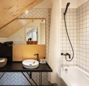 a bathroom with a sink and a bath tub at Major's House Hotel in Stepʼanavan