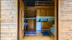 a kitchen with wooden cabinets and a table at Una Kamp in Bosanska Krupa