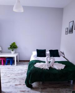 a bedroom with a bed with two swans on it at Apartament Evita in Karpacz