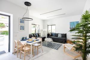 a living room with a table and a couch at Cozy Corner Luxury Apartments in Chania Town
