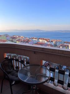 una mesa y sillas en un balcón con vistas en Sun & More Apartment, en Crikvenica