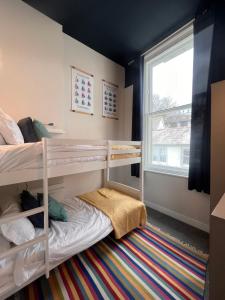 a kids room with bunk beds and a window at The Cornish Bank Flats in Falmouth