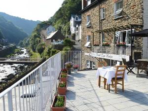 a patio with a table and chairs on a balcony at East Lyn House in Lynmouth