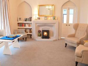 a living room with a fireplace and a fire place at East Lyn House in Lynmouth