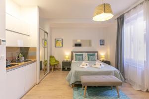 a small bedroom with a bed and a kitchen at Polai Center Apartments in Pula