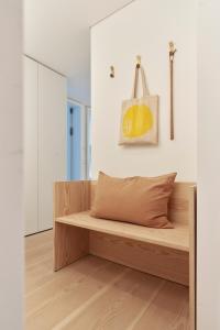 a bed in a room with a yellow bag on the wall at Inselhouse in Norderney