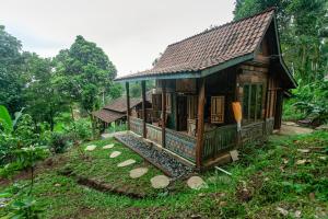 a small house in the middle of a forest at Tepi Sawah Lodge & Retreat in Jatiluwih