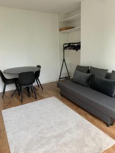 a living room with a couch and a table at Suite minimalist 50m2 in Brussels